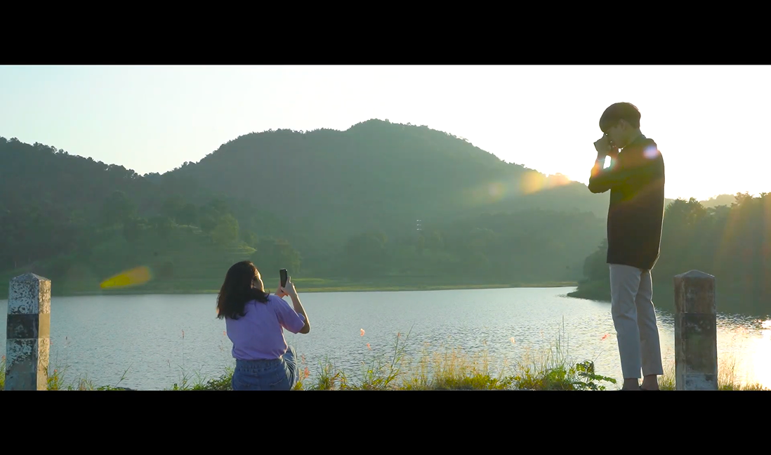 December short film still — the couple riding a motorcycle