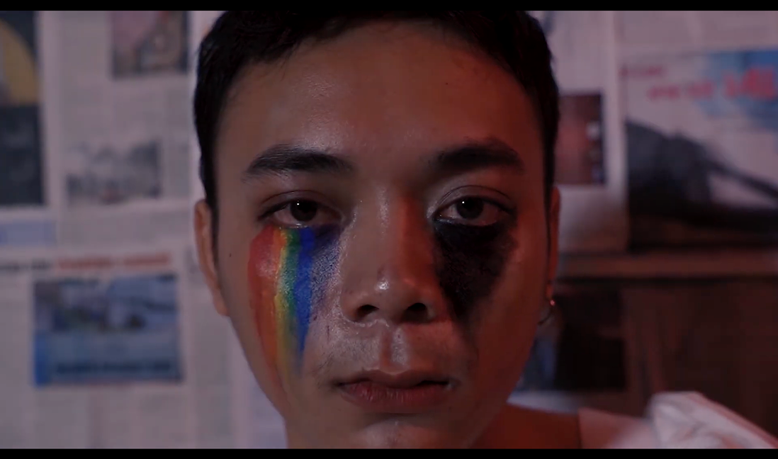 Advertising film still — close-up with rainbow and black painted tears