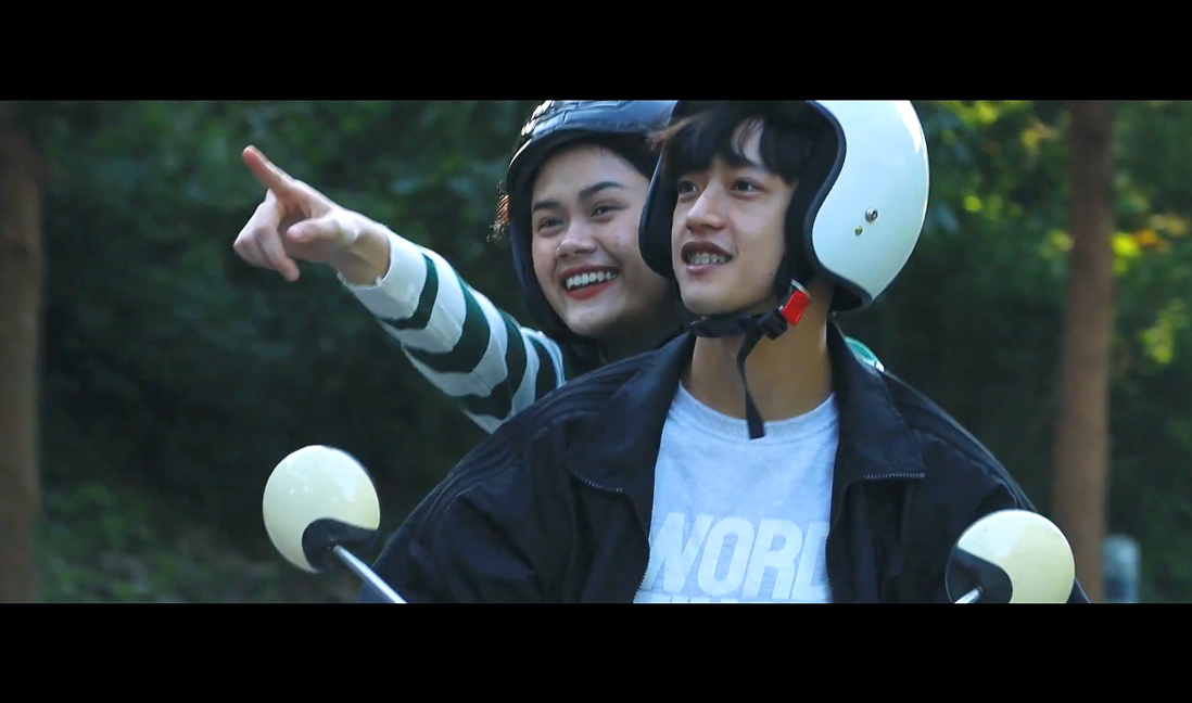 December short film still — the couple talking at a shop entrance