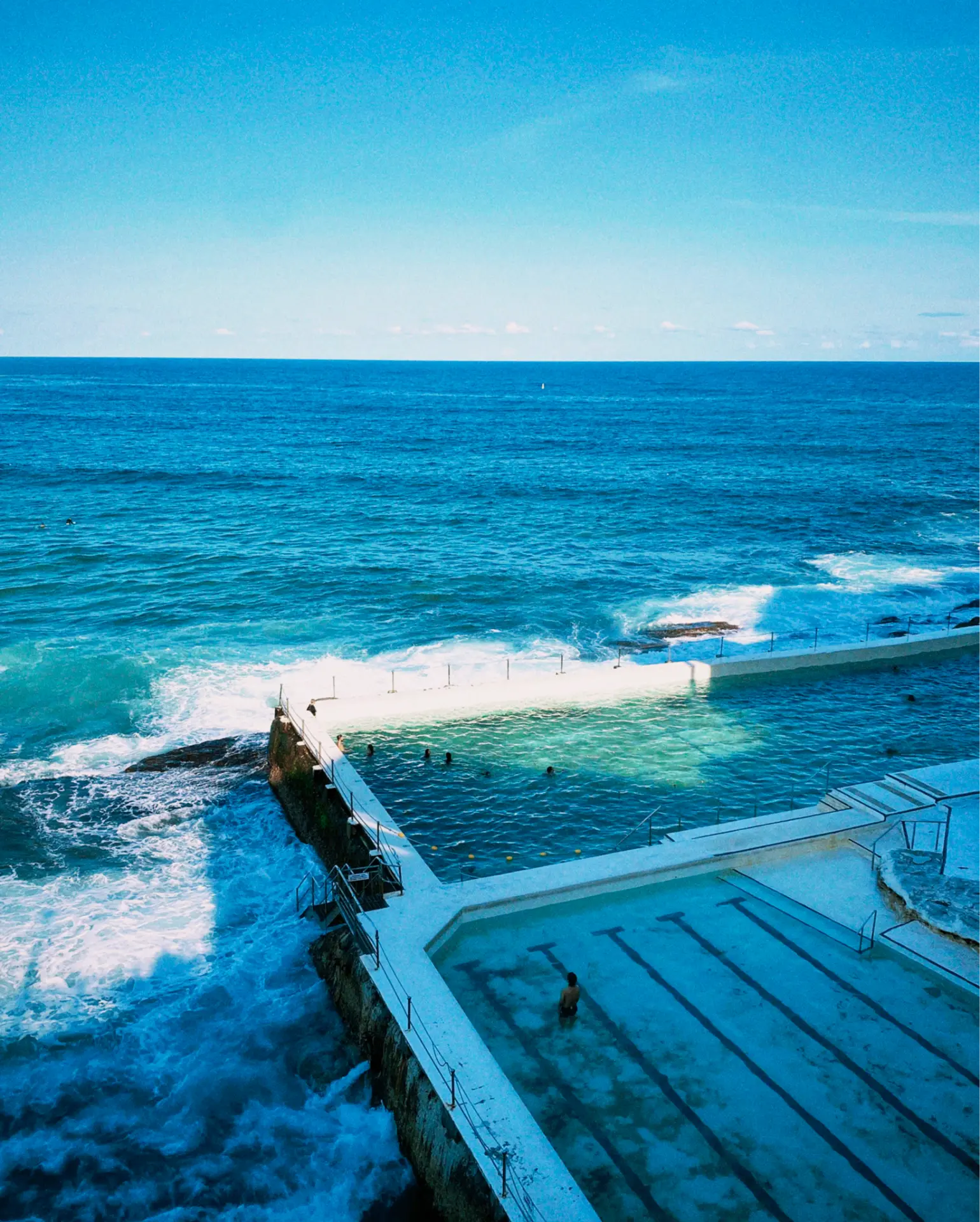 Oceanfront swimming pool beside crashing waves and the open sea