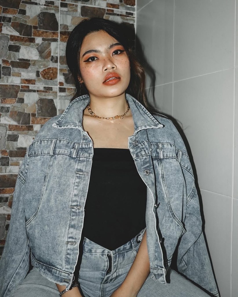 Woman in a denim jacket looking at the camera