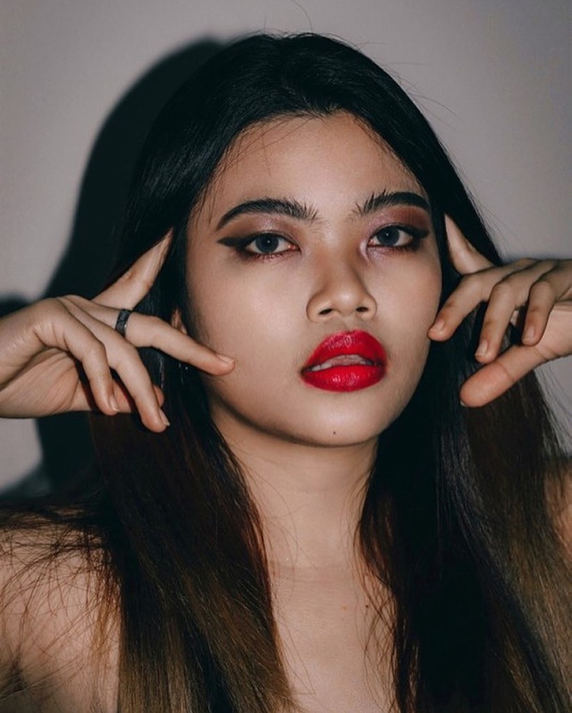 Woman posing with fingers framing her face